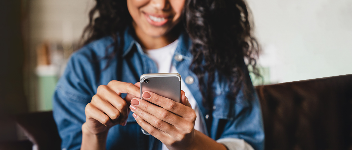 Woman placing bid on smartphone app during silent auction