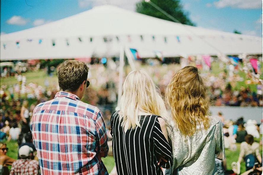 Three friends attending a local fundraising event thanks to an awareness campaign.